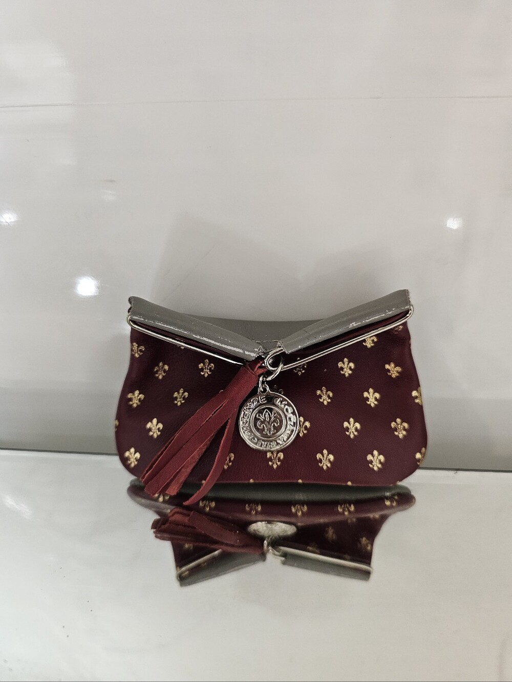 Ponte Vecchio Maroon Clutch with Gold Fleur Motifs and Tassel Charm